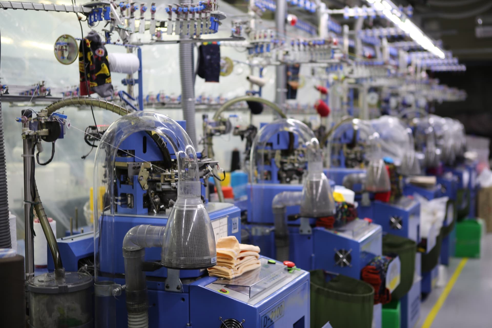 Circular sock knitting machines on the Valortex factory floor in Uijeongbu